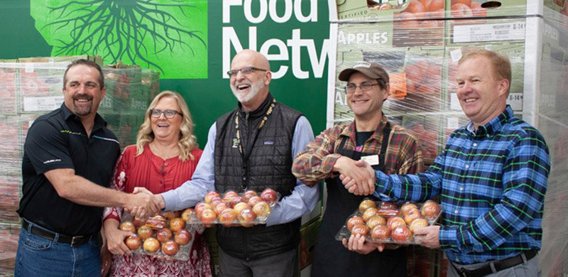 Charlies Produce Spokane and Good Food Store make donation of 3,800 pounds of apples